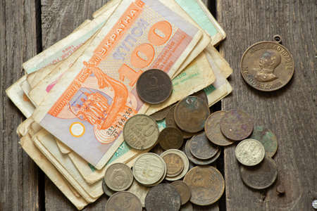 monetary unit of the Ukrainian state coupon and coins of the ussr lie on the table, old soviet money, coins and coupons, financeの写真素材