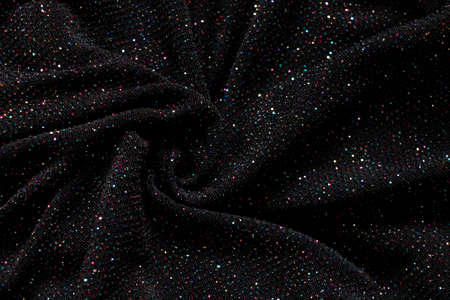 black crumpled fabric with multicolored sequins as background, shiny fabric for backgroundの写真素材