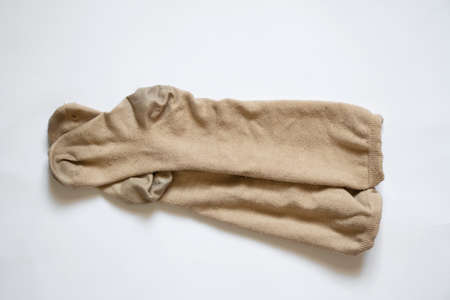dirty brown womens long socks on white background, worn socksの写真素材