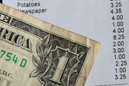 a check from the supermarket is on the table, a paper check with purchases, finances totalsの写真素材