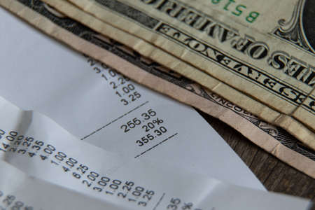 a check from the supermarket is on the table, a paper check with purchases, finances totals