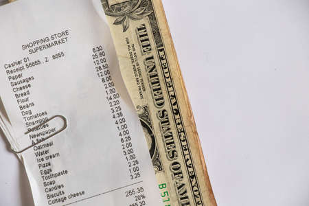 a check from the supermarket is on the table, a paper check with purchases, finances totals