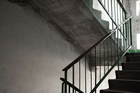 old dirty soviet entrance in an apartment building after a fire, a corridor in the entrance, a staircaseの写真素材