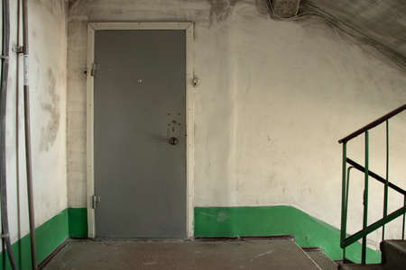 old dirty soviet entrance in an apartment building after a fire, a corridor in the entrance, a staircaseの写真素材
