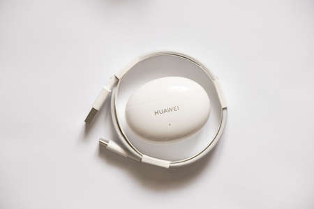 Ukraine Dnepr 08.10.2021 - Headphones Huawei FreeBuds 4i (White) new with packaging lie on a white...