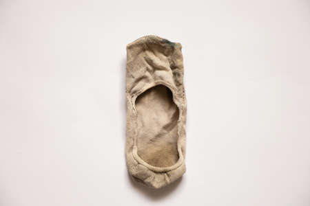 old short dirty light socks on white background, dirty socks, short socksの写真素材