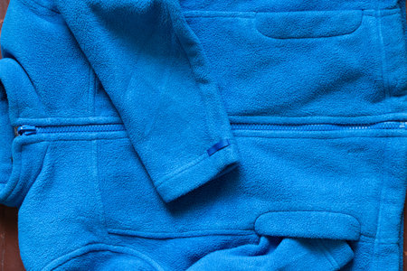 fleece blue sports jacket, artificial fabric as background, fleece sweaters background, tire soft warm fabric as backgroundの写真素材