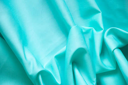 light blue fabric wrinkled as background, blue fabric for backgroundの写真素材