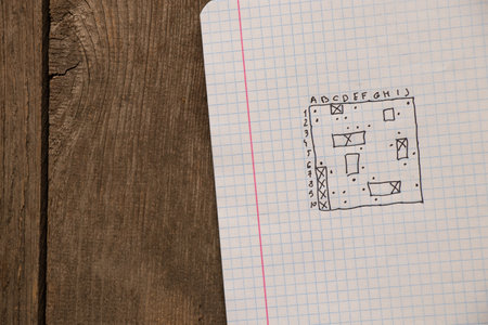 sea battle game, hand-drawn with a pen in a white notebook, rest on a break, school game, child's sea battleの写真素材