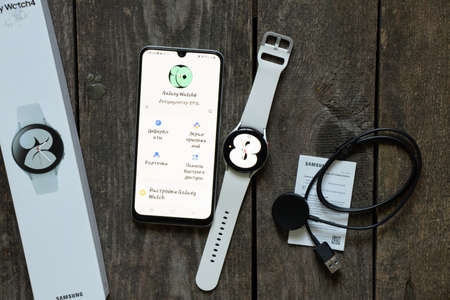 Ukraine Dnipro 11/30/2021 - Smart watch Samsung Galaxy Watch 4.40 mm and mobile phone with app for...