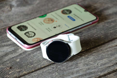 Ukraine Dnipro 11/30/2021 - Smart watch Samsung Galaxy Watch 4.40 mm and mobile phone with app for watch, phone and watchのeditorial素材