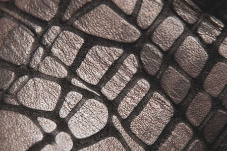 embossed python skin of gray burgundy color as a background, leather background, snake skin as a...