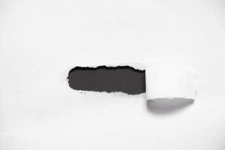 white torn paper with a hole in the middle, torn paper, space for text, white paper backgroundの写真素材