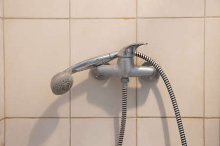 shower faucet with a watering head on a long hose in the bathroom, shower cabin with a faucet