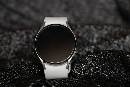 Ukraine Dnepr 11.12.2021 - Smart watch Samsung Galaxy Watch 4 track with a gray strap on an isolated background and an application, a new watch a giftのeditorial素材