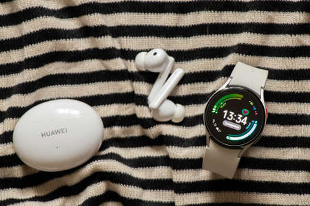 Ukraine Dnipro 11/30/2021 - Smart watch Samsung Galaxy Watch 4.40 mm and wireless headphones, fitness watches and headphones, new technologiesのeditorial素材