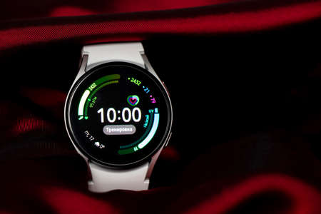 Ukraine Dnipro 11/30/2021 - Smart watch Samsung Galaxy Watch 4.40 mm and a mobile phone with an...