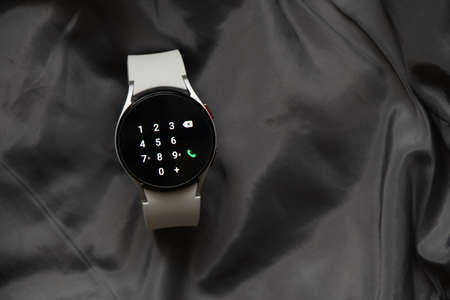 Ukraine Dnipro 11/30/2021 - Smart watch Samsung Galaxy 4.40 mm and mobile phone with application for...