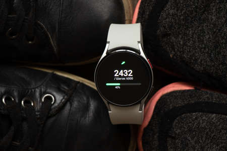 Ukraine Dnipro 11/30/2021 - Smart watch Samsung Galaxy 4.40 mm and a mobile phone with an...