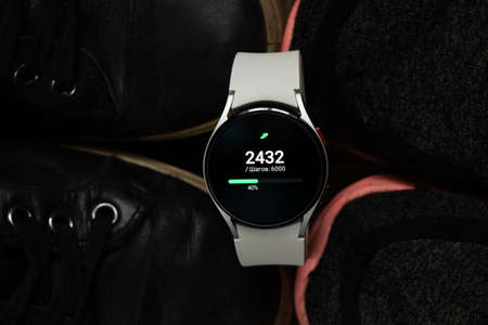 Ukraine Dnipro 11/30/2021 - Smart watch Samsung Galaxy 4.40 mm and a mobile phone with an...