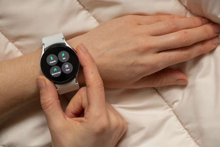 Ukraine Dnipro 11/30/2021 - Smart watch Samsung Galaxy 4.40 mm and a mobile phone with an...