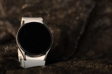 women smart watch with white strap lie on isolated background, smart watch, fitness braceletの写真素材