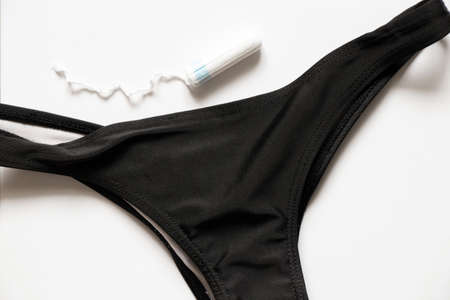 white tampon lies on women's panties, hygiene product on menstrual days, tampon, menstrualの写真素材