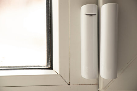window opening sensor hanging on the window, home alarm system, home protection, home alarmの写真素材