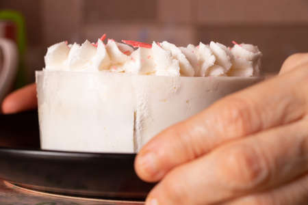birthday cake on the table at home and mom's hands, holiday birthday, cakeの写真素材