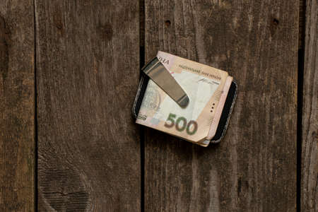 Ukrainian money in a money clip on an isolated background, financeの写真素材