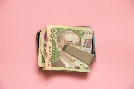 Ukrainian money in a money clip on an isolated background, financeの写真素材