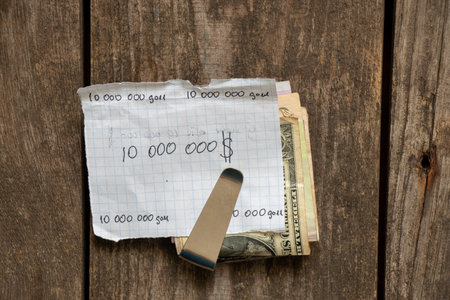 dollars in wallet and one million dollar handwritten check on the table, million dollar dream, plans for successの写真素材
