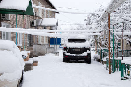 Ukraine Dnipro 26.12.2021 - City in winter with cars in the snow and people trying to get to the robot in the morning after snowfall, winter in the cityのeditorial素材