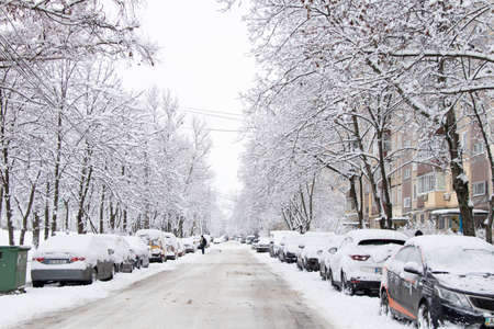 Ukraine Dnipro 26.12.2021 - City in winter with cars in the snow and people trying to get to the robot in the morning after snowfall, winter in the cityのeditorial素材