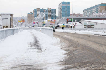 Ukraine Dnipro 26.12.2021 - City in winter with cars in the snow and people trying to get to the robot in the morning after snowfall, winter in the cityのeditorial素材