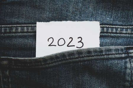 2023 written on paper that lies in the pocket of jeans, happy new year 2023, holiday and fashionの写真素材