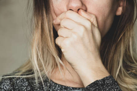 the girl covered her mouth with her hand, stop stop and shut up, be careful with the wordsの写真素材