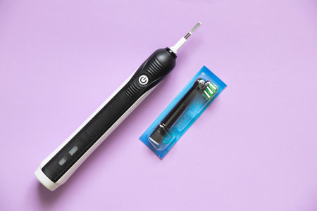 Ukraine Dnipro 02.01.2022 - Oral-B Braun toothbrush on a wooden table, unboxing, dental care for a giftのeditorial素材