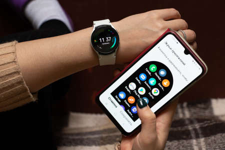 Ukraine Dnepr 06.01.2021 - Smart watch Samsung Galaxy 4.40 mm and a mobile phone with an application...