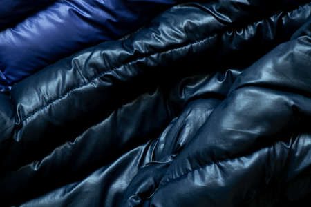 black puffed men's winter jacket as background, down jacket close-upの写真素材