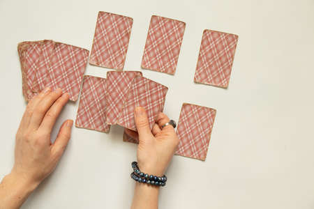 fortune-telling cards in the hands of a girl, a layout on cards for predicting fate by cards