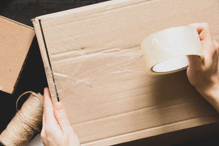 Women's online store, small business owner, entrepreneur, packing bag, mailbox preparing parcel on the table for shipping. Dropshipping delivery concept in e-commerce.Product packagingの写真素材