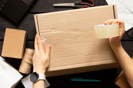 Women's online store, small business owner, entrepreneur, packing bag, mailbox preparing parcel on the table for shipping. Dropshipping delivery concept in e-commerce.Product packagingの写真素材