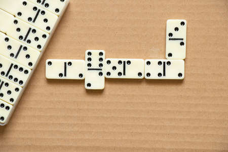 dominoes on brown paper closeup,domino effectの写真素材