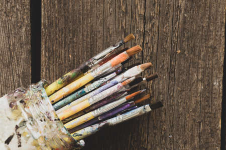 brushes in watercolor paint on an isolated background closeup ,hobby and creativity artistの写真素材