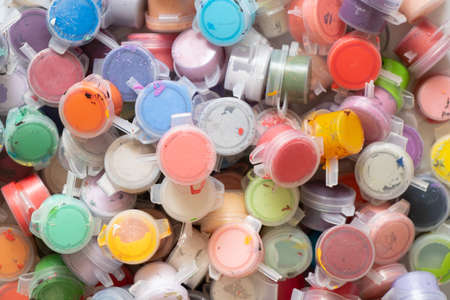 a lot of multi-colored watercolor paints in plastic jars close-up as a background, hobby and creativity artistの写真素材
