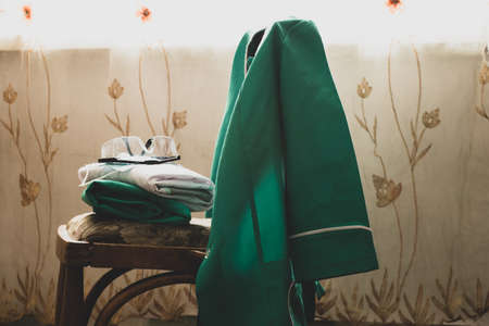 medical uniform on the table in the office, medicine and health, medical uniform