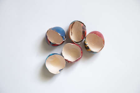 eggshell painted with paints lies on a white background close up