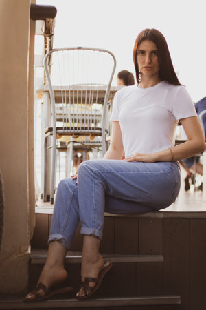 a girl sits on a pleasure ship on the deck in the summer in the sun in Ukraine, a girl sits on the...