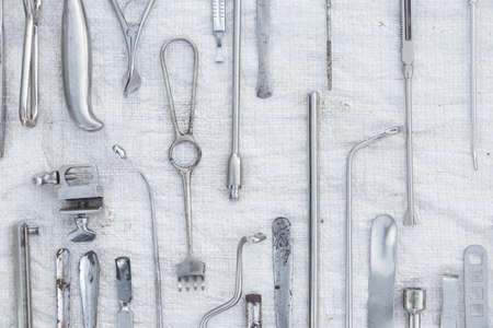 set of old medical instruments clamps ,scalpels and scissors on a white background ,medical practiceの写真素材